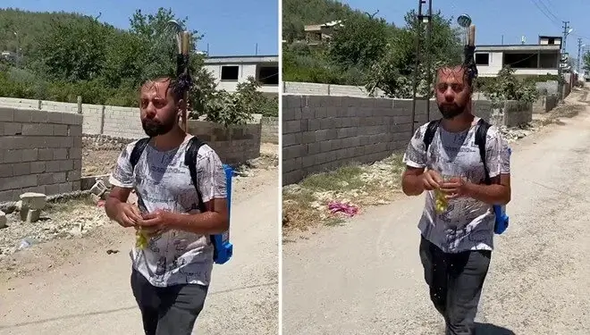 50 dərəcə istiyə maraqlı həll: Kürəyində duş başlığı ilə gəzdi